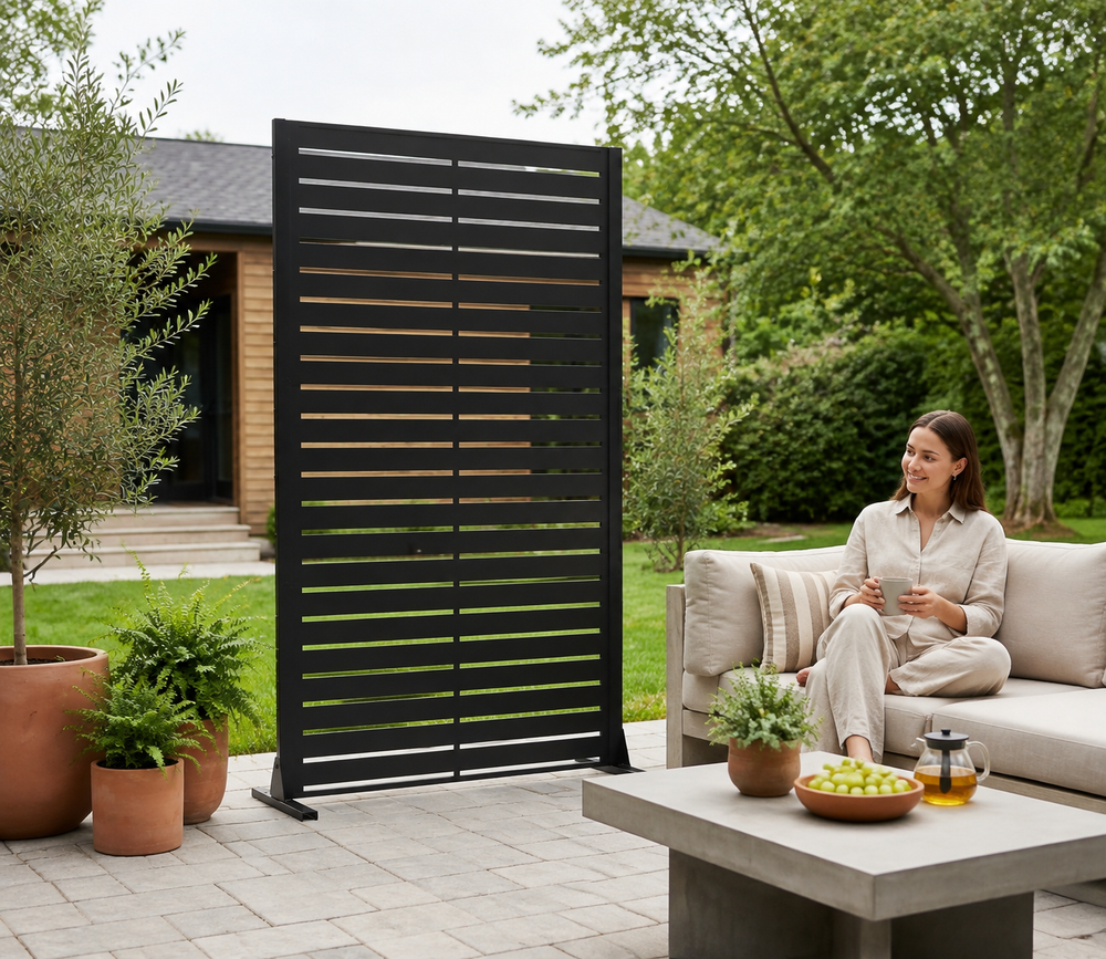 Mixed-width louvered metal privacy screen creating privacy on a backyard patio