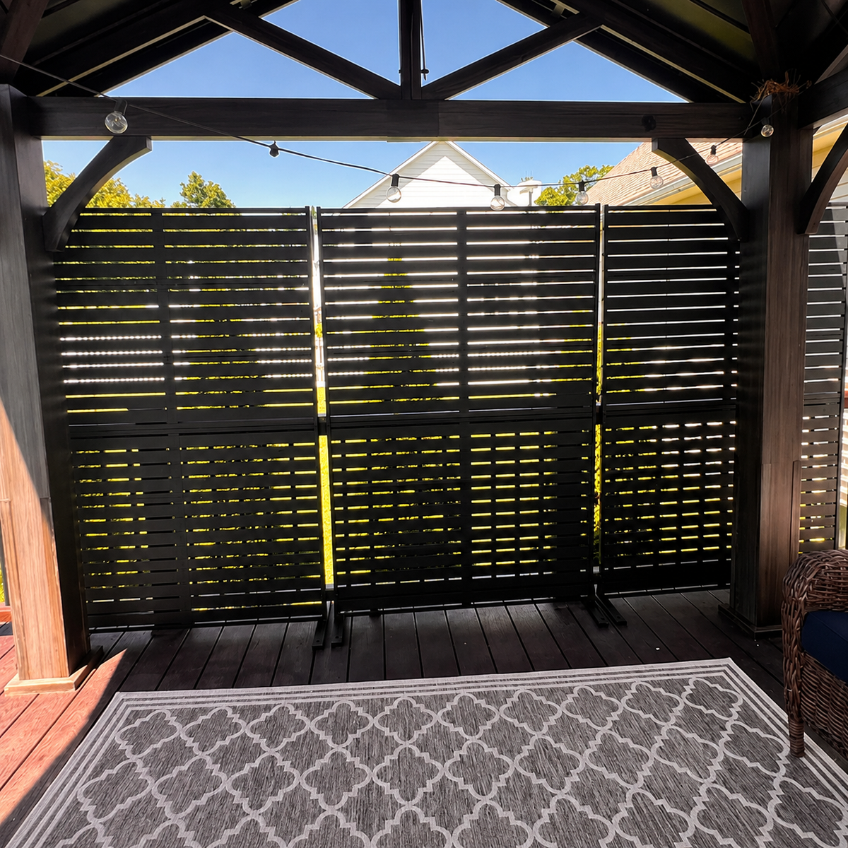 Backyard privacy screen installation showing a finished outdoor living area