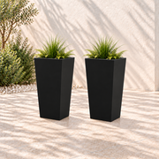 Two black tapered metal planters, each 26 inches high with greenery in an outdoor setting.