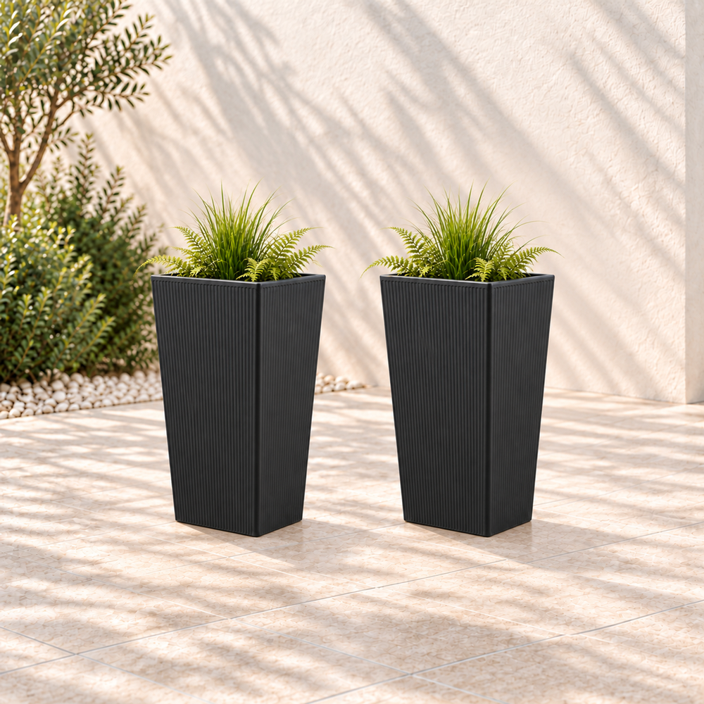Two black ribbed polyethylene planters, each 28.3 inches high with greenery in an outdoor setting.