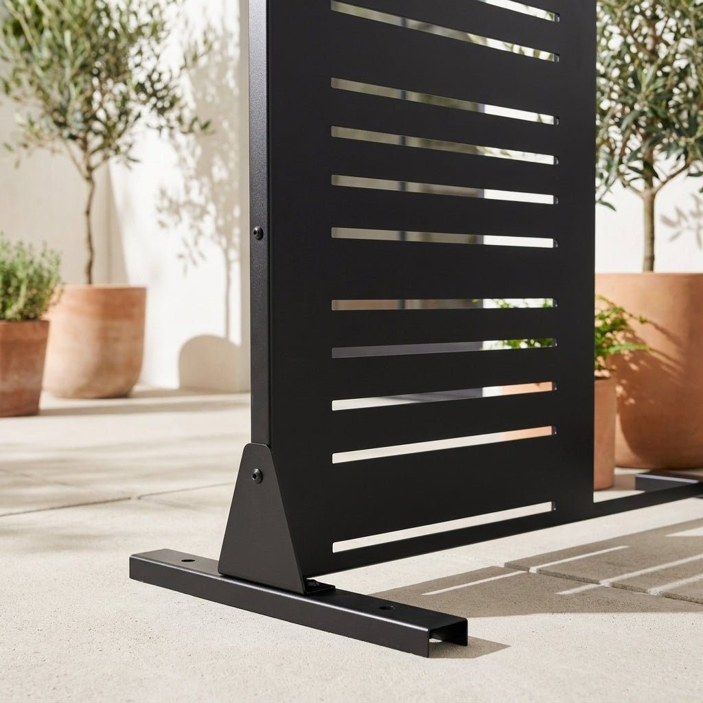 Close-up of mixed-width louvered metal privacy screen frame and base detail