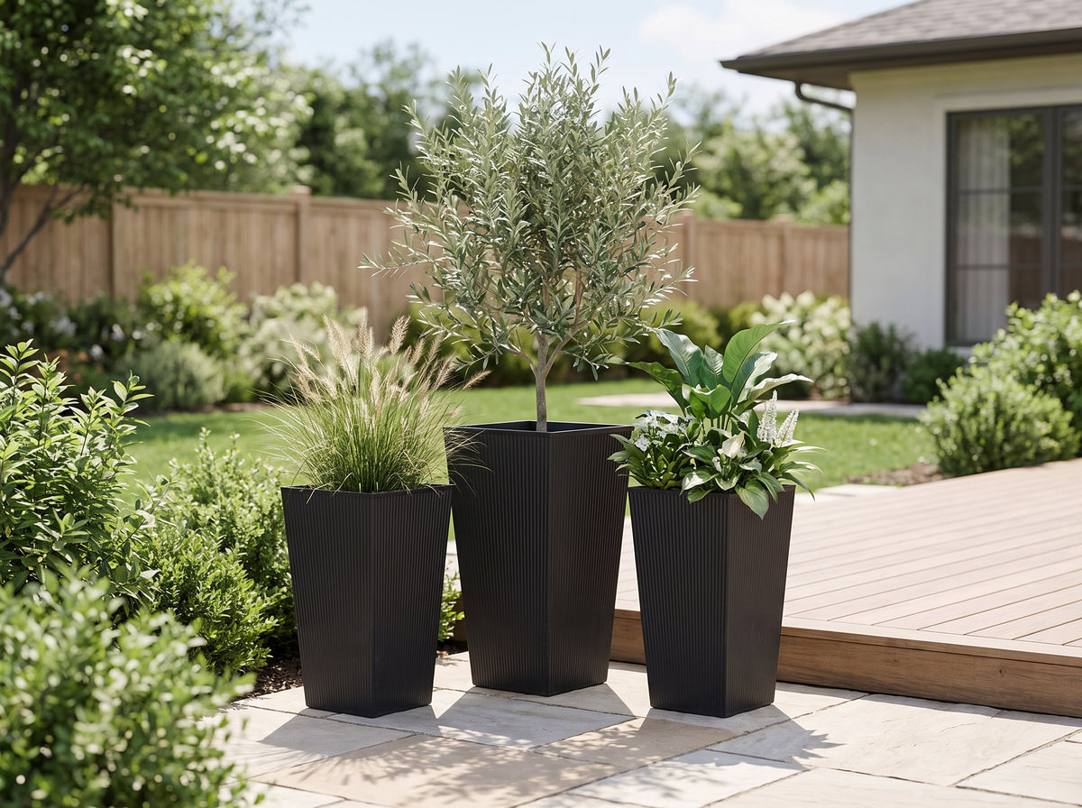 Modern outdoor planters with layered greenery on a bright backyard patio